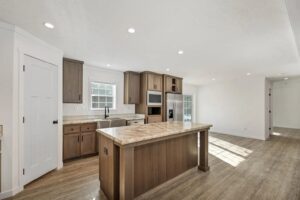 Open-concept kitchen with island inside a manufactured home sold by Northern Mobile Homes, a manufactured home dealer in Ashland NH