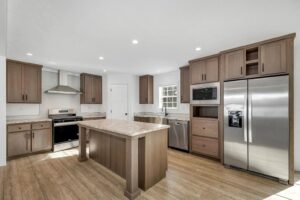Modern kitchen with island inside a manufactured home sold by Northern Mobile Homes, a manufactured home dealer in Ashland NH