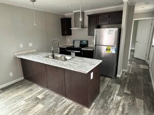 Modern kitchen with island inside a manufactured home sold by Northern Mobile Homes, a mobile home dealer in Rochester NH