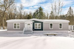 Winter exterior of a manufactured home sold by Northern Mobile Homes, a manufactured home retailer serving New Hampshire
