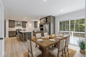 Open-concept kitchen and dining area inside a manufactured home sold by Northern Mobile Homes, a manufactured home dealer serving Maine