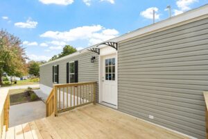 Manufactured home with exterior deck sold by Northern Mobile Homes, a mobile home dealer in New Hampshire