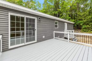 Rear deck and sliding glass door of a manufactured home sold by Northern Mobile Homes, a manufactured home dealer serving Massachusetts